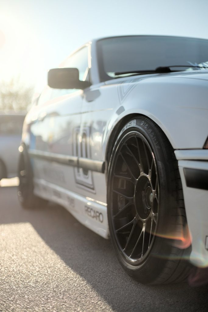 a-close-up-of-a-white-car-on-a-street-anxv4mkqe1q